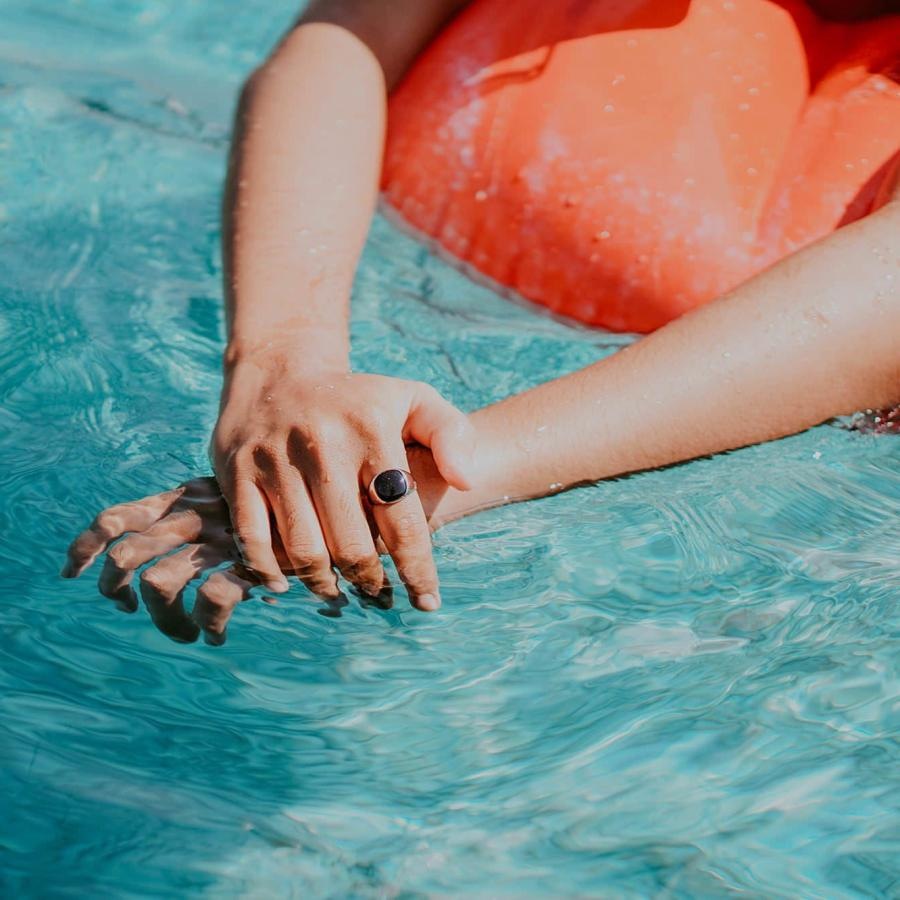 woman relaxes on a floatie in swimming pool