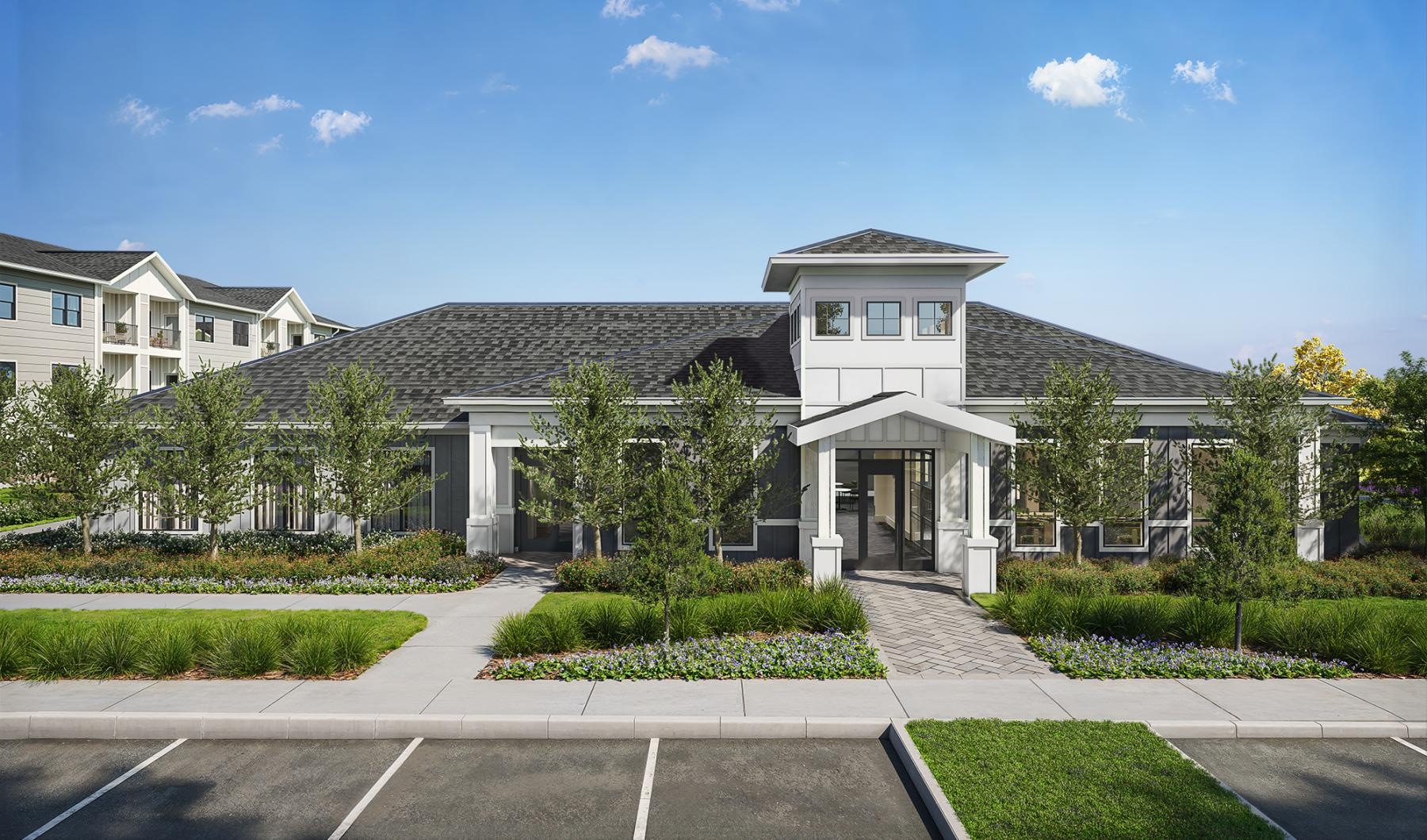 a leasing office with a parking lot and trees