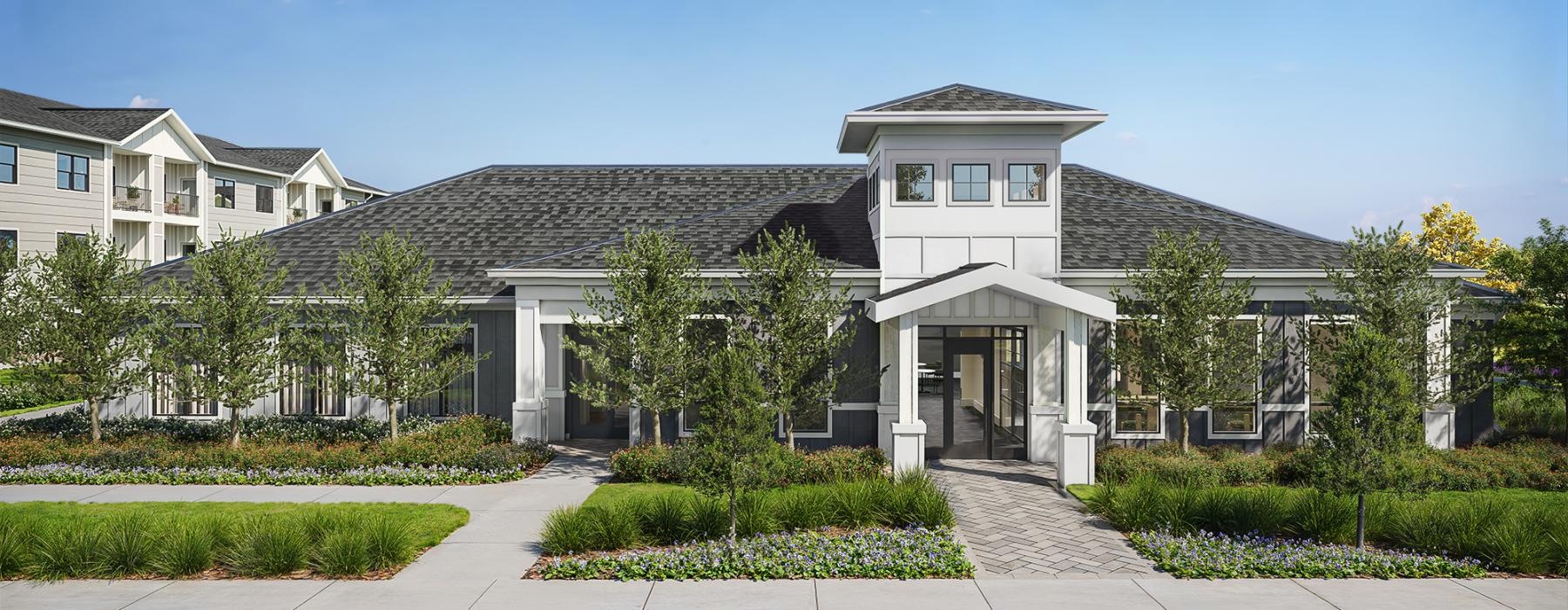 a leasing office with a parking lot and trees
